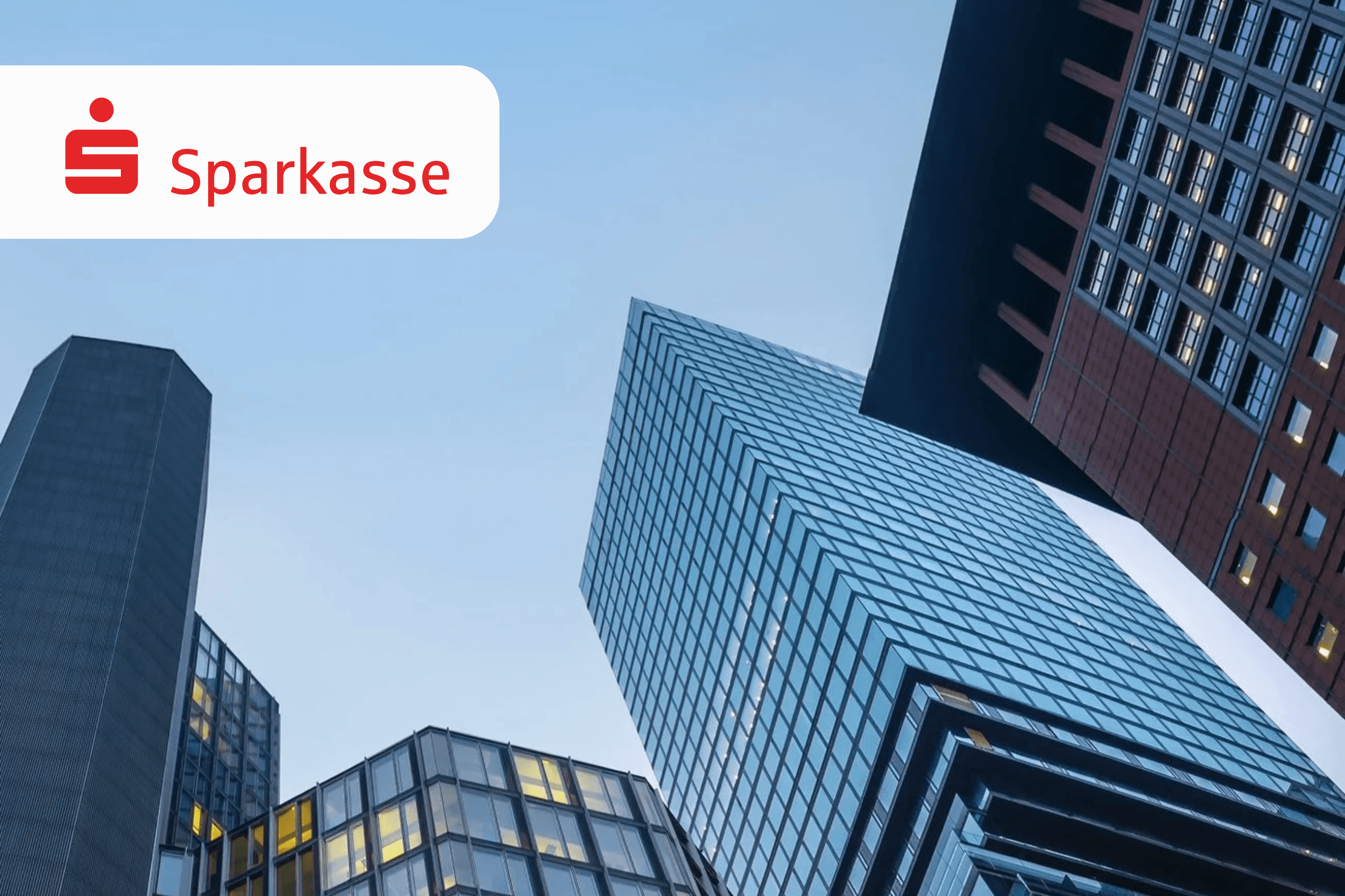 Modern glass skyscrapers loom upwards with the Sparkasse logo prominently displayed.